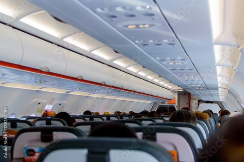 Interior of airplane with passengers on seats waiting to take off
