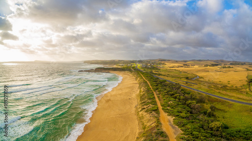 Glowing sunset over ocean coastline in Australia - aerial view photo