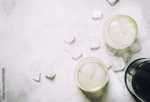 Festive Alcoholic Cocktail Prosecco On The Rocks With Dry Sparkling Wine And Ice Cubes, Gray Stone Background, Top View