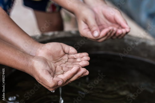 The hands of children who need water.