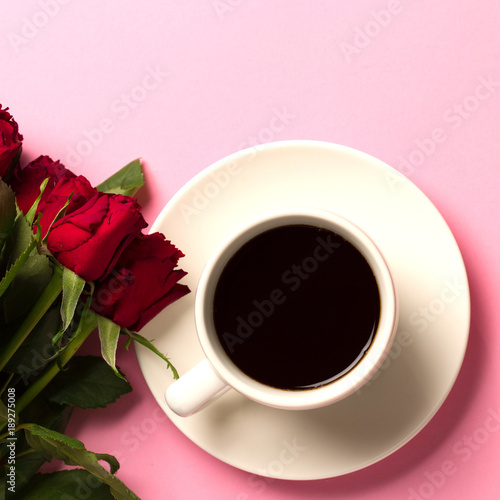 Morning concept background with rose and a cup of coffee. Top view with space for your text