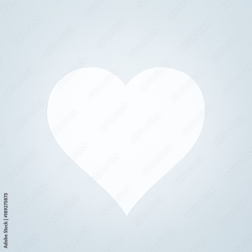 White heart on a pastel background. Valentine day concept. Trendy minimalistic flat lay design background