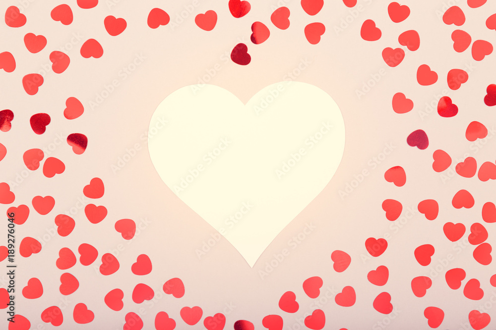 White heart with glitter heart confetti. Valentine day concept. Trendy minimalistic flat lay design background