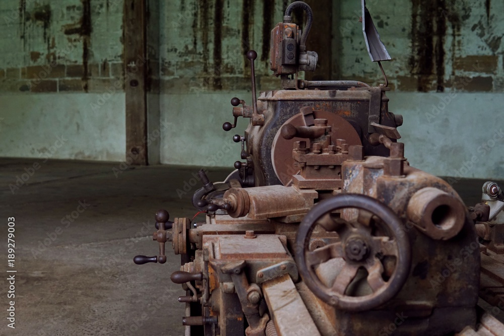 Grain Image: Close up of old machine factory made of steel and used in the past. Broken and rustic machine left over in abandon factory. Image of aged equipment with rust and gear part. Grain Image: Close up of old machine factory made of steel and used in the past. Broken and rustic machine left over in abandon factory. Image of aged equipment with rust and gear part.