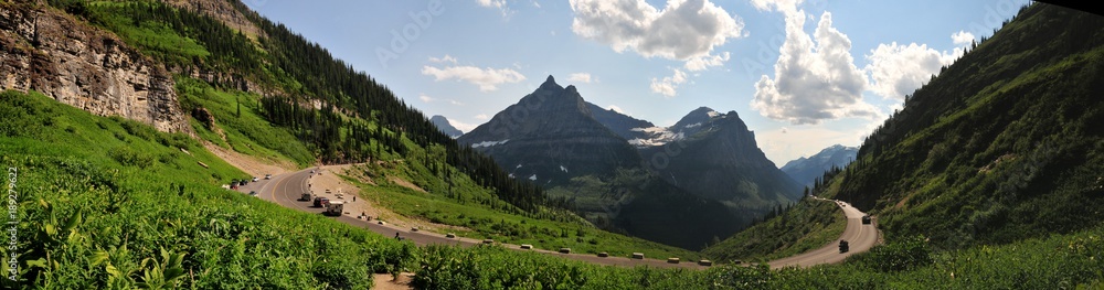 Fototapeta premium Going to sun road, west glacier, Montana, Panoramic view of circular road and mountain range. One of the most picturesque road to drive in summer. 
