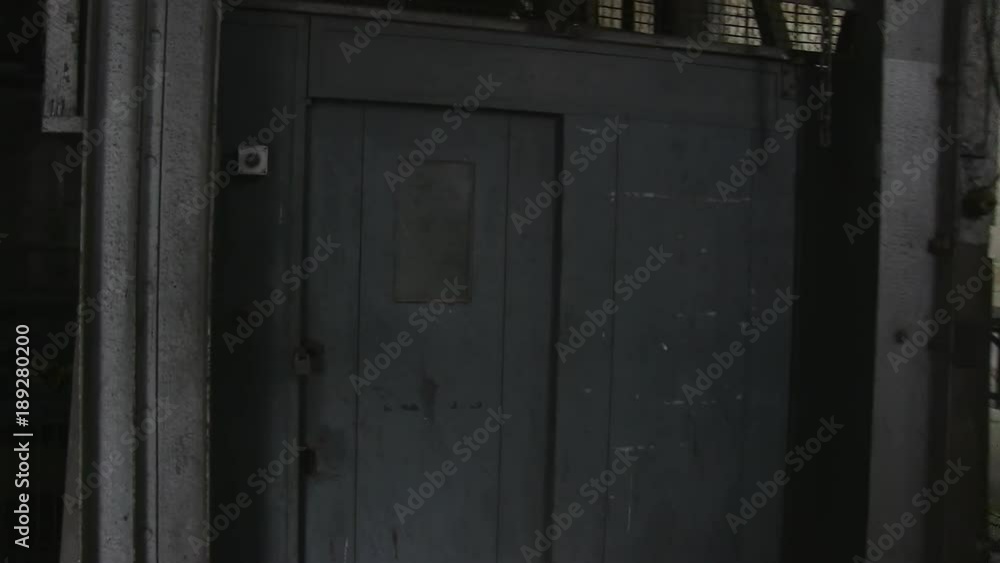 A medium shot of a metallic grey door. Camera moves forward A medium shot of a metallic grey door. Camera moves forward