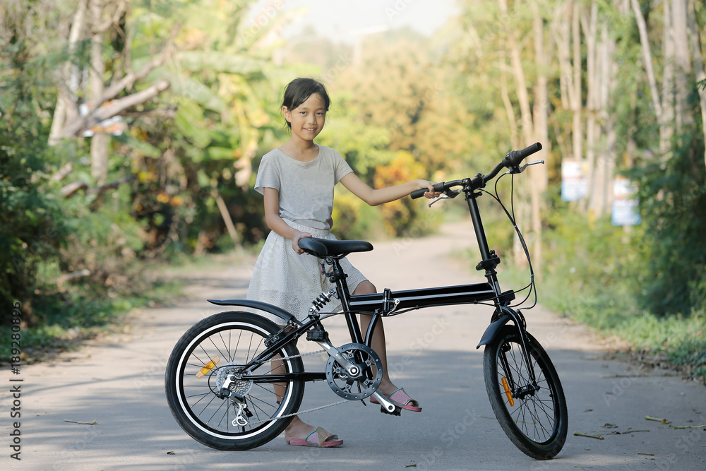 Fototapeta premium child girl with folding bike