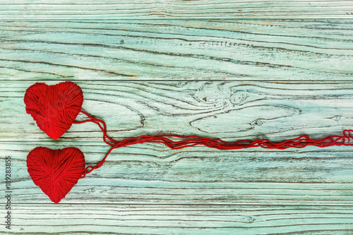 Heart in the form of a string of threads from which a red sweater knits. Valentines day concept.