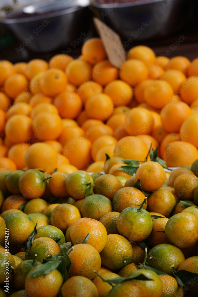 Mandarins with leaves of greenery on the counter at the fruit market in Spain