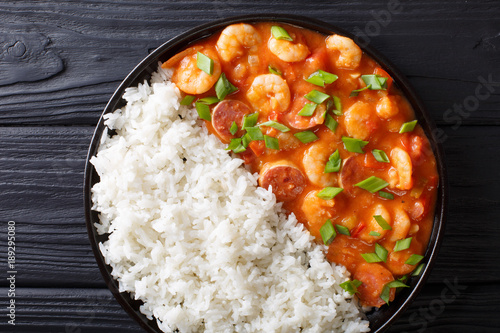 Fotografie Traditional Louisiana gumbo with shrimp, sausage and rice macro on a plate