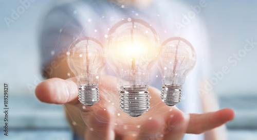 Businessman connecting modern lightbulbs with connections 3D rendering
