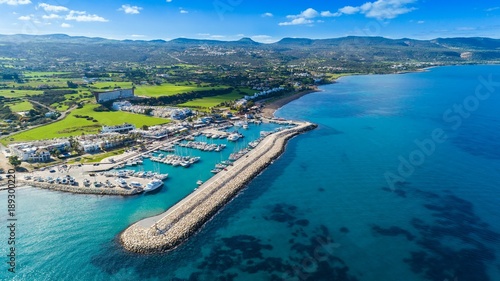 Aerial bird's eye view of Latchi port,Akamas peninsula,Polis Chrysochous,Paphos,Cyprus. The Latsi harbour with boats and yachts, fish restaurant, promenade, beach tourist area and mountains from above photo