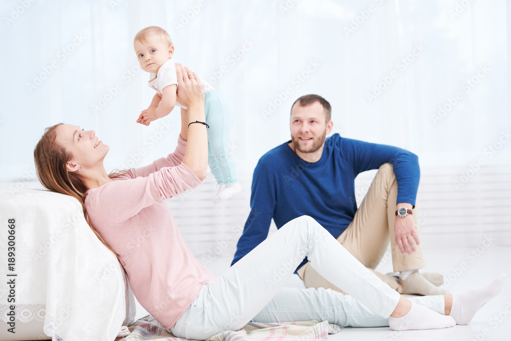 Parenting family. Mother and father playing with little newborn baby Parenting family. Mother and father playing with little newborn baby