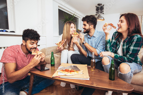 Group of young friends eating pizza.Home party.Fast food concept.