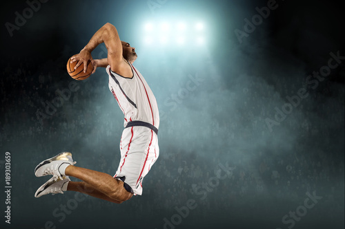 Caucassian Basketball Player in dynamic action with ball in a pr © Andrii IURLOV
