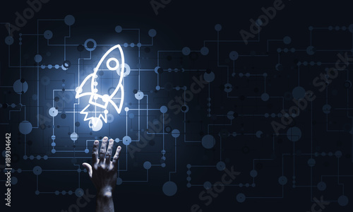 Technology idea concept with glowing rocket icon and touching it finger