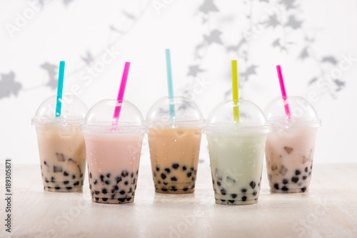 Fefreshing iced milky bubble tea with tapioca pearls in plastic cup