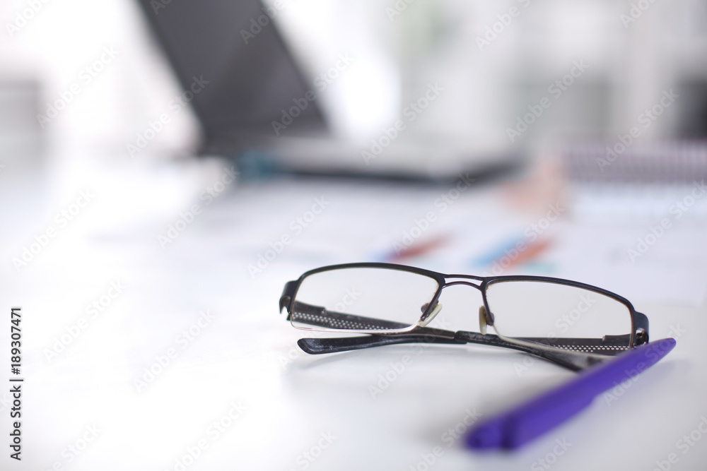 glasses on your desktop. work with drawings. business plan. stapler, magnifier glasses on your desktop. work with drawings. business plan. stapler, magnifier