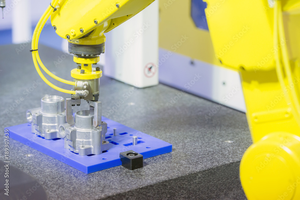 The robot arm for take the aluminium part .Industrial 4.0 concept for modern manufacturing. The robot arm for take the aluminium part .Industrial 4.0 concept for modern manufacturing.