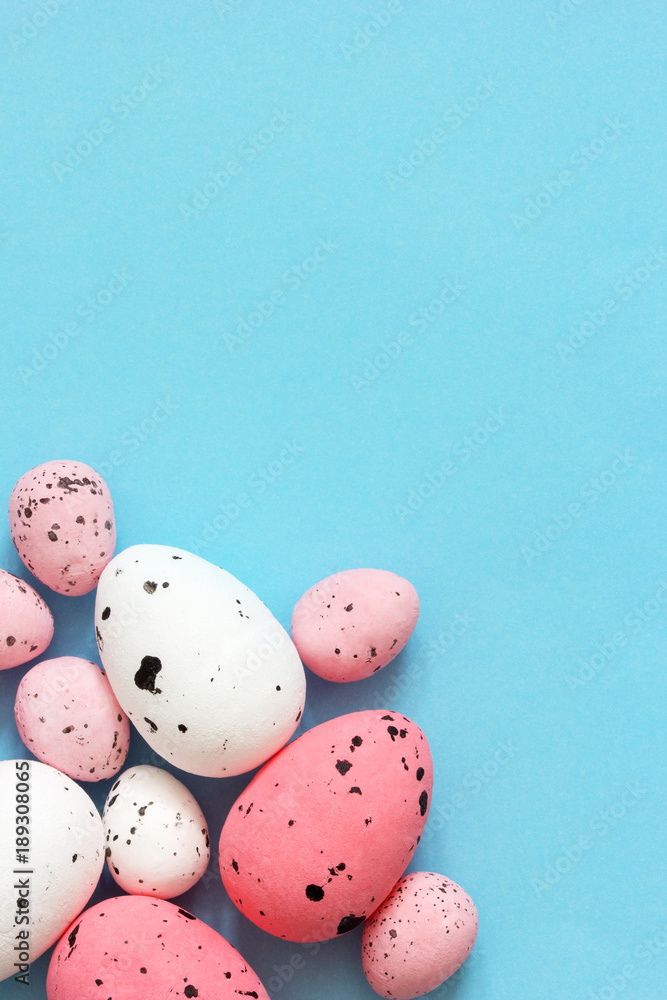 Colorful quail eggs on a blue background. Easter background.