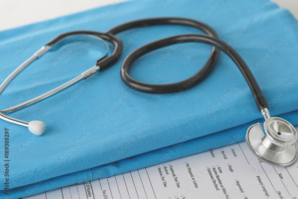 Stethoscope on a table with medical uniform Stethoscope on a table with medical uniform