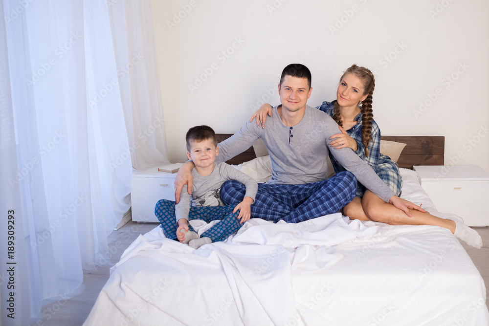 mom dad and son lie on the bed at home dream mom dad and son lie on the bed at home dream
