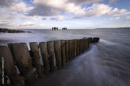 The wooden groynes and dolphin structures at Lepe in Hampshire. © Chris