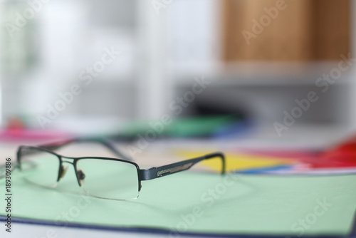 glasses on your desktop. work with drawings. business plan. stapler, magnifier
