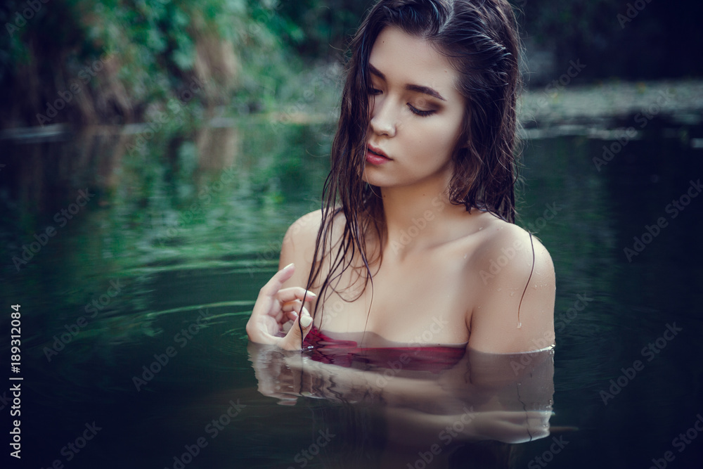 Beautiful young girl resting in water