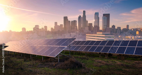 photovoltaic panels on sunrise front of the big city photo