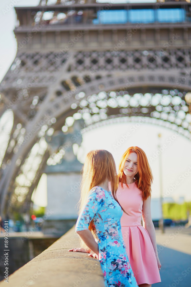 Two friends near the Eiffel tower in Paris, France