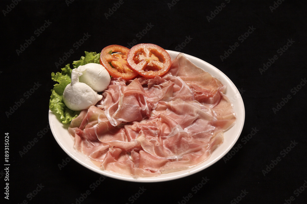 raw parma ham with mozzarella