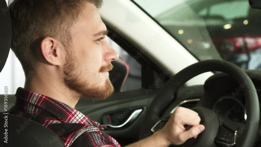 Close up of a happy handsome male car ownes smiling with car keys in his hand Close up of a happy handsome male car ownes smiling with car keys in his hand