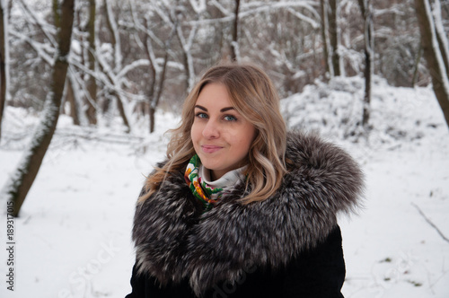 Young woman in winter portrait. The girl in the winter park