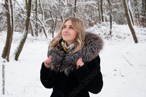 Young woman in winter portrait. The girl in the winter park