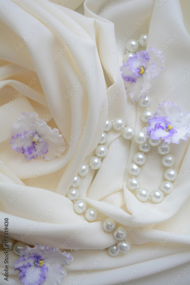 pearl beads on a delicate background with flowers violets, wedding gift pearl beads on a delicate background with flowers violets, wedding gift