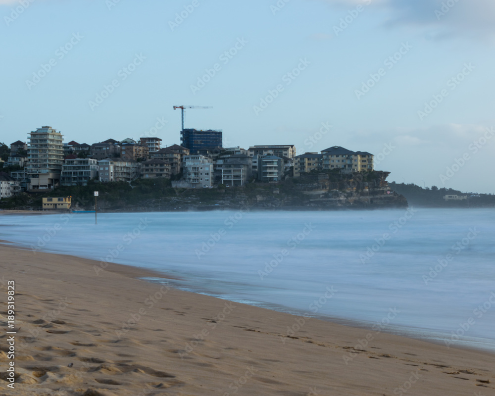 Manly Beach with milky long exposure water looking across to Queenscliff Head - Sydney, Australia