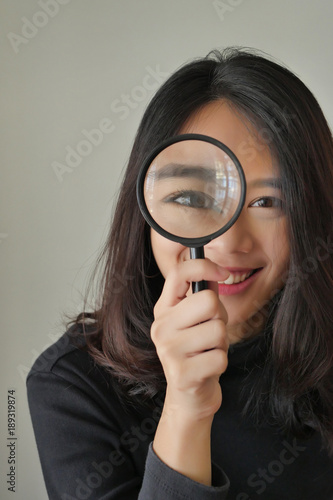 woman searching, viewing, finding with magnifying glass, girl searching concept