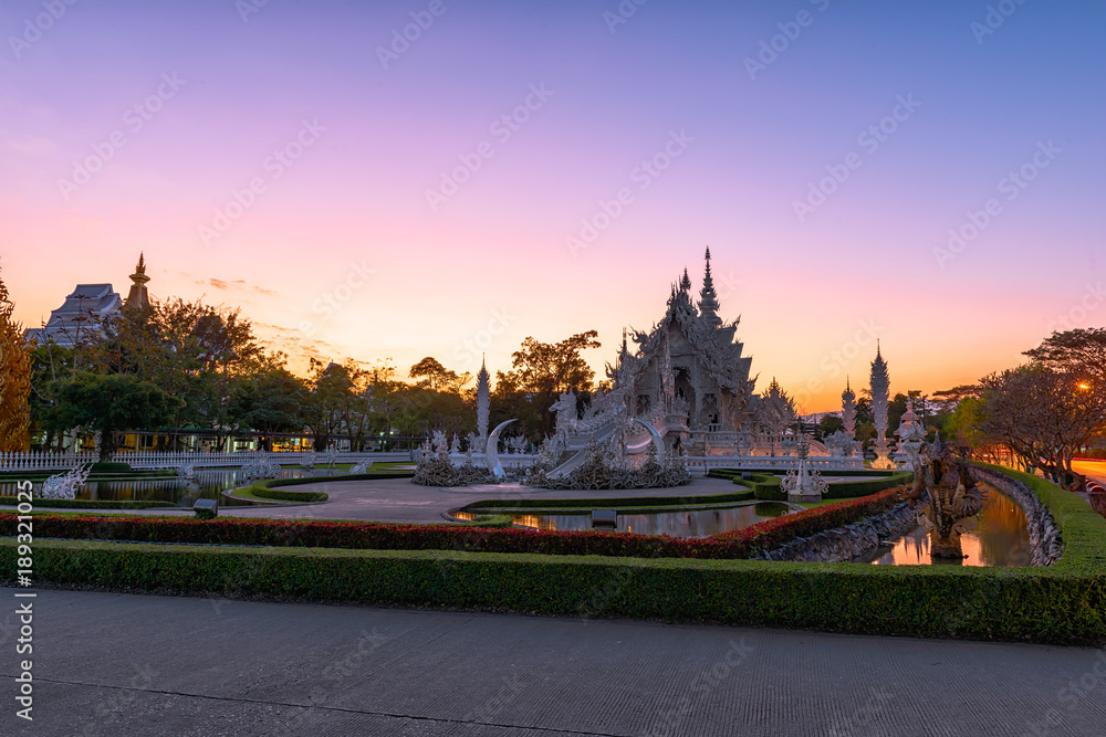 Wat Rong Khun(White temple)at sunset in Chiang Rai,Thailand.23/01/2018 Wat Rong Khun is modern building, well known worldwide.It was designed by Chalermchai Kositpipat.Opened it to visitors in 1997.