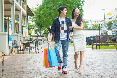 Young couple Asian in white and black dress. Shopping bags enjoying on street city. Shopping Concept © Akira Kaelyn