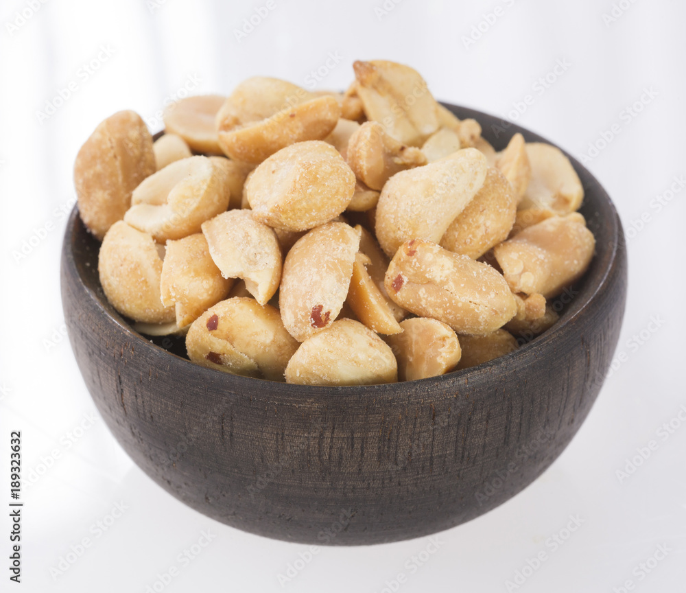 Toasted peanuts on wooden background - Arachis hypogaea Toasted peanuts on wooden background - Arachis hypogaea