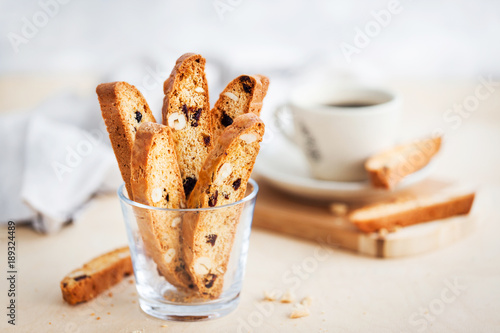 Italian cranberry almond biscotti  and cup of coffee on background Fototapeta