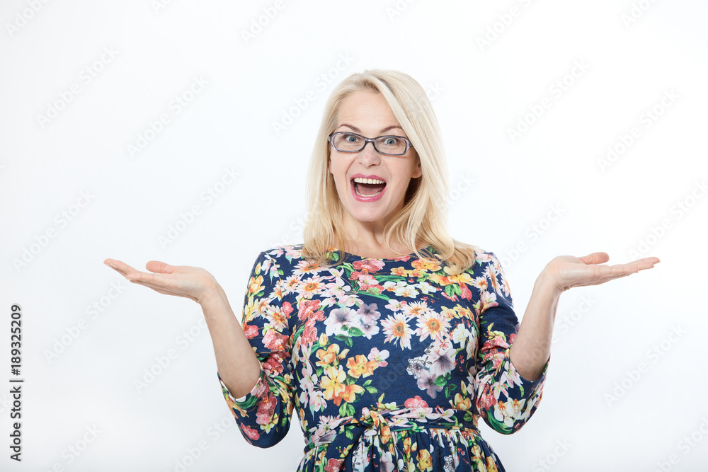 Surprised beautiful woman with eyeglasses in blue dress on white background. Human face expression, emotions, feeling attitude reaction Surprised beautiful woman with eyeglasses in blue dress on white background. Human face expression, emotions, feeling attitude reaction