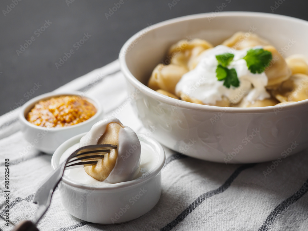 Dumplings on plate at wooden desk on black background Dumplings on plate at wooden desk on black background