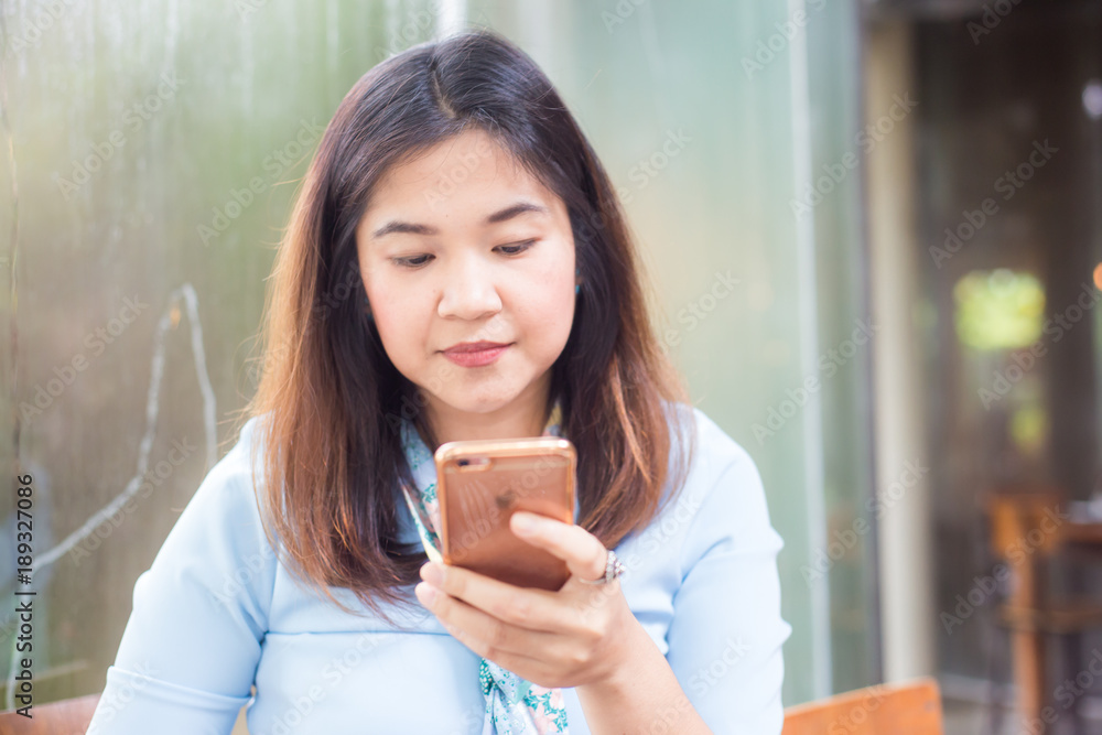 Beautiful young hipster asian women using application to send message on cellphone Beautiful young hipster asian women using application to send message on cellphone