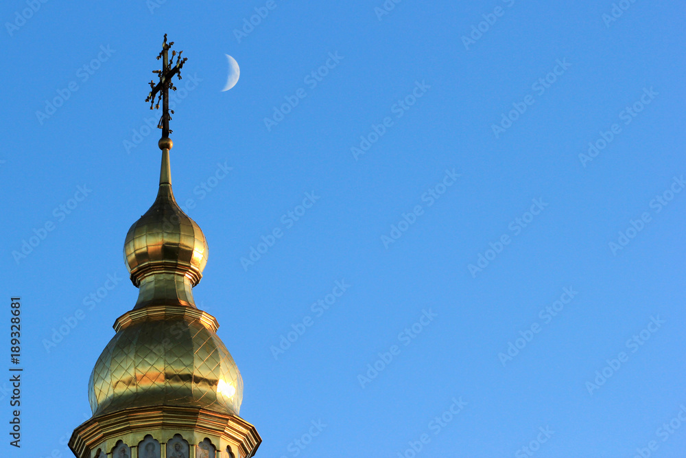 Crescent moon near the cross on top of St. Michael's Golden-Domed Monastery in Kyiv, Ukraine