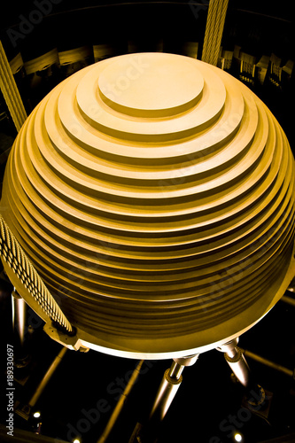The 660-tonne golden steel pendulum which serves as a tuned mass damper (TMD). It stabilizes the tower against movements caused by high winds. Visitors can admire it between the 87th and 91st floors.