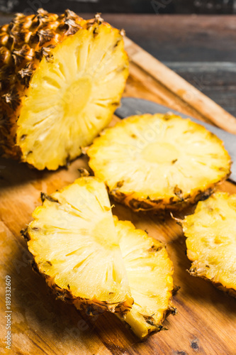 Fresh ripe pineapples on the rustic background. Selective focus.