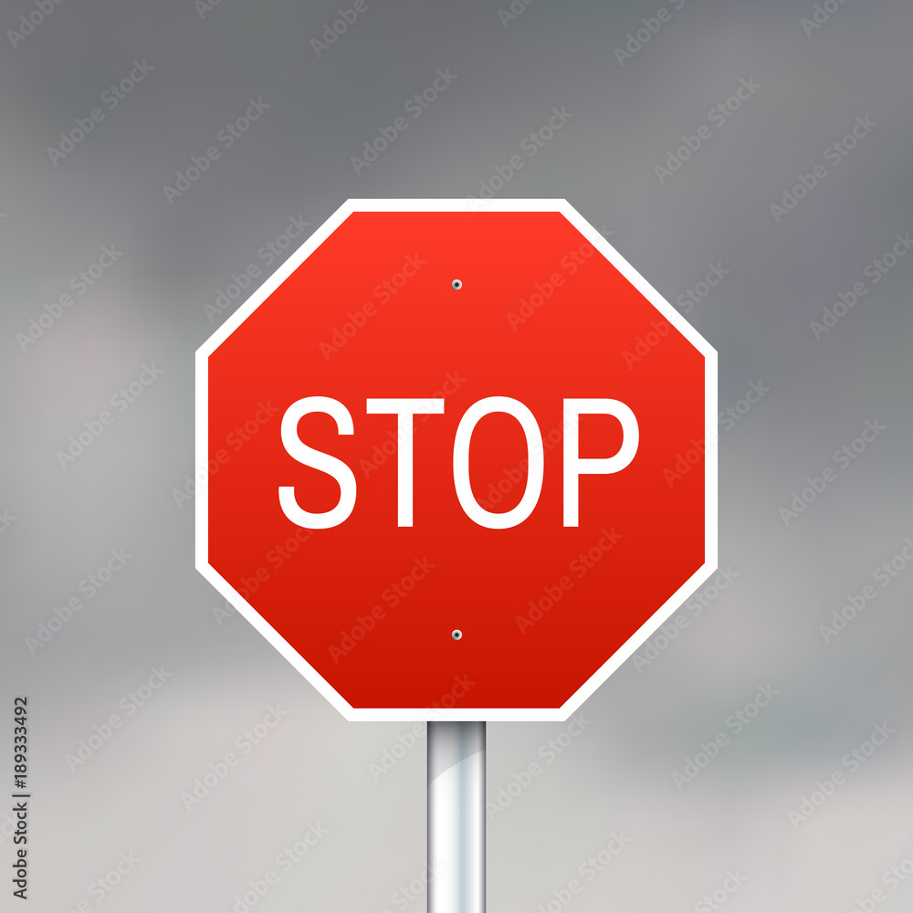 Red stop sign on gray sky background Red stop sign on gray sky background