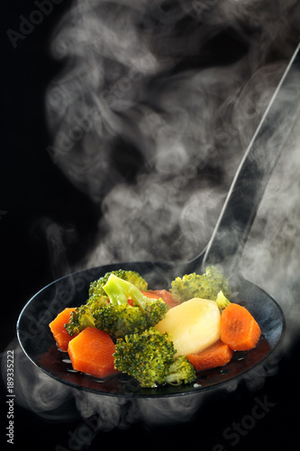 Steamed vegetables and steam.
